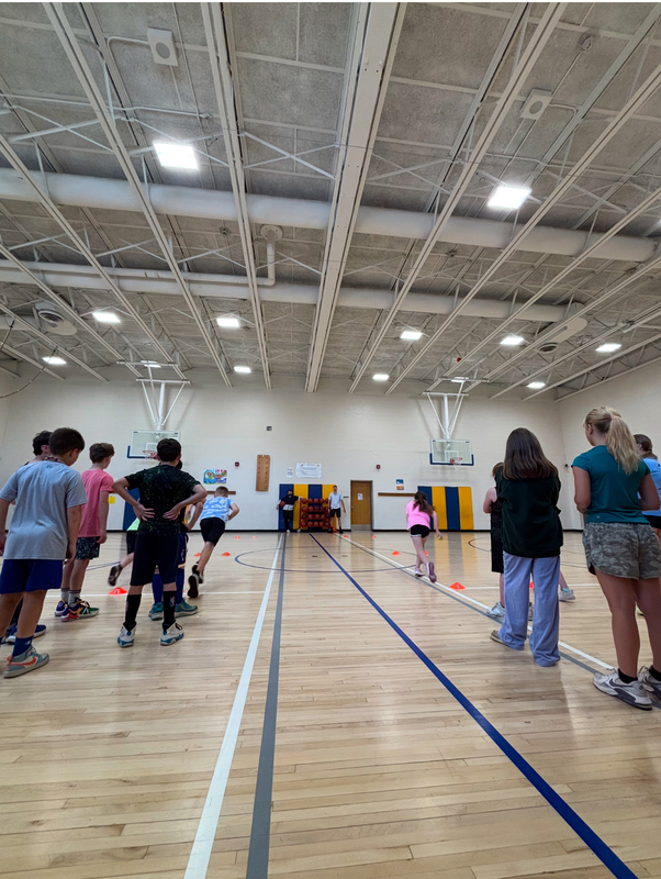 GES morning open gym time photo of kids getting ready to race in the gym