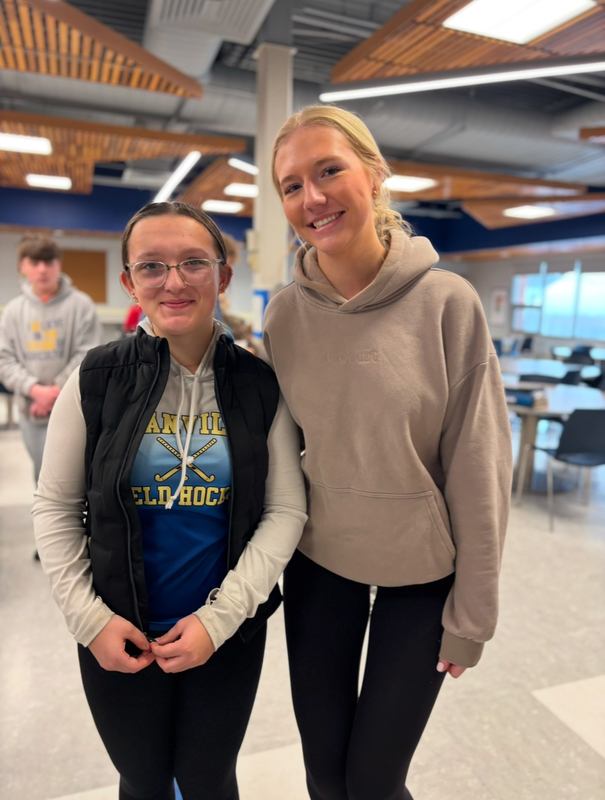 Two students a mentee on left and a mentor on right, stand in the granville jr/sr high cafeteria