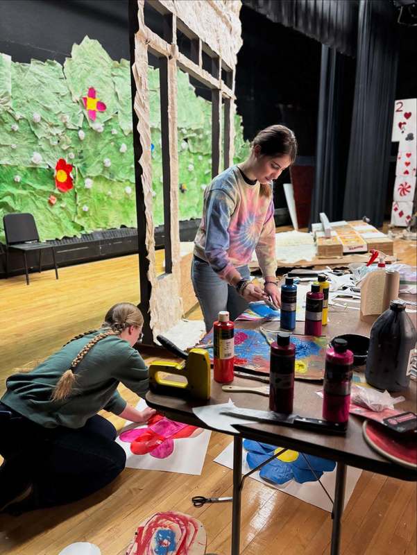 A student and family friend work on the set of Alice in Wonderland adaptation