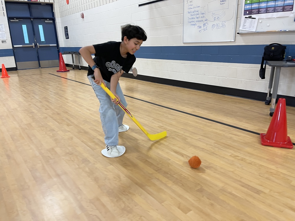 Student playing hockey
