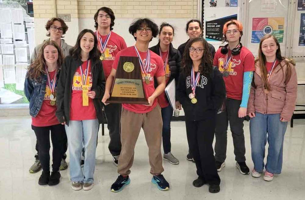 Students holding trophy