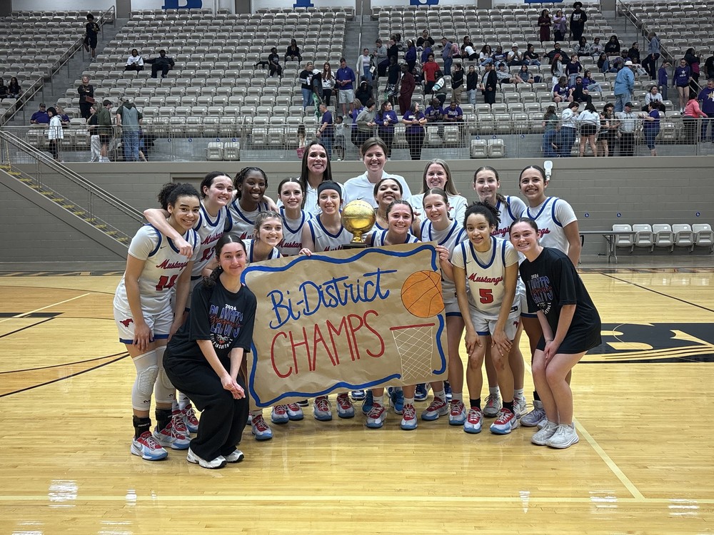 Grapevine Girls Basketball Team Posing with bi-district championship trophy