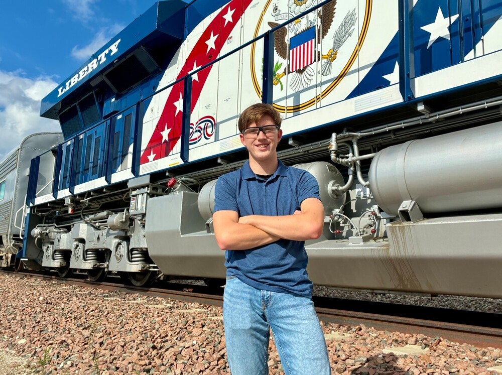 Student in front of train