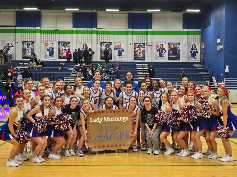 Grapevine High School Ladies Basketball Posing in a team photo after the area championship victory.