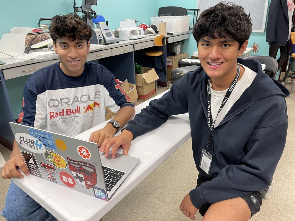 Two students in front of computer