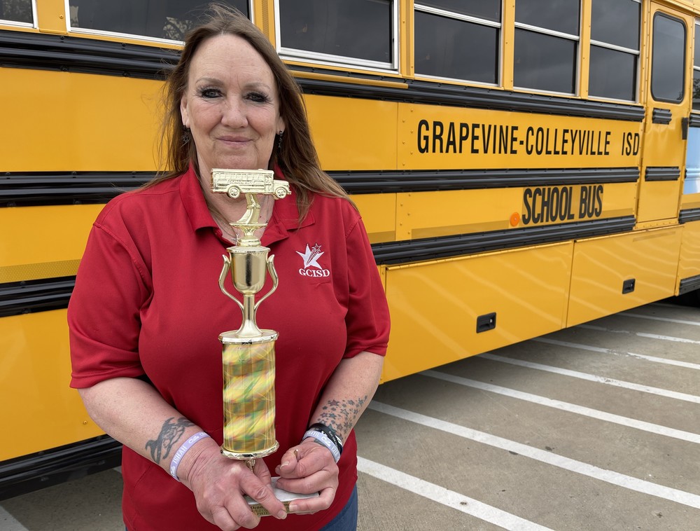 Transportation driver holding trophy