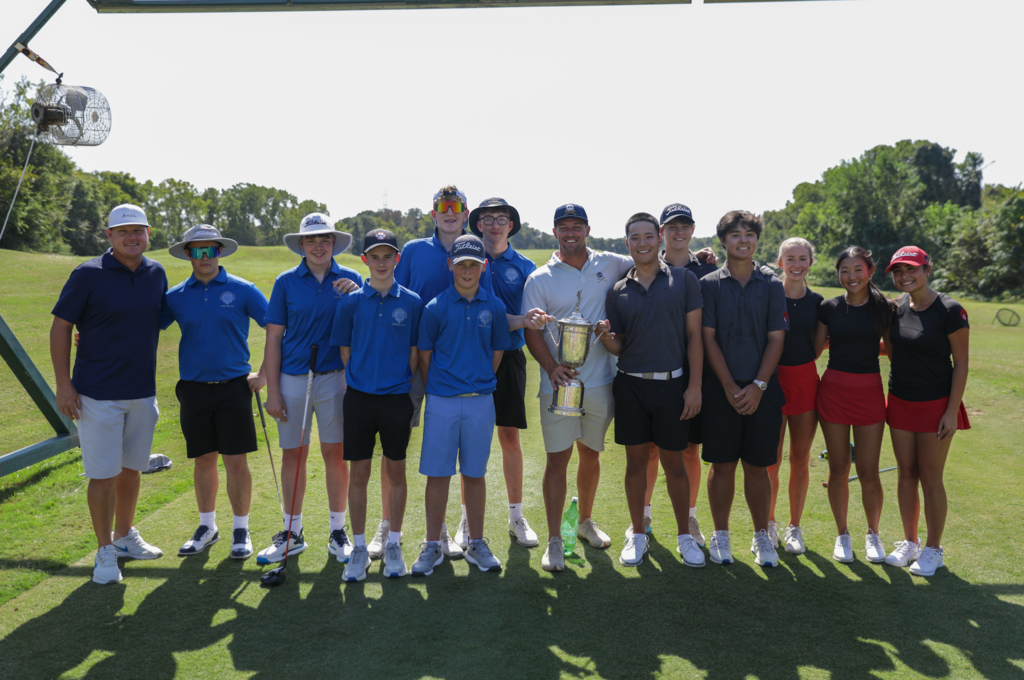 Golf teams posing with a trophy