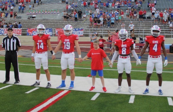 Junior captain with football players