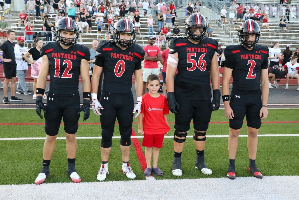 Junior captain with football players