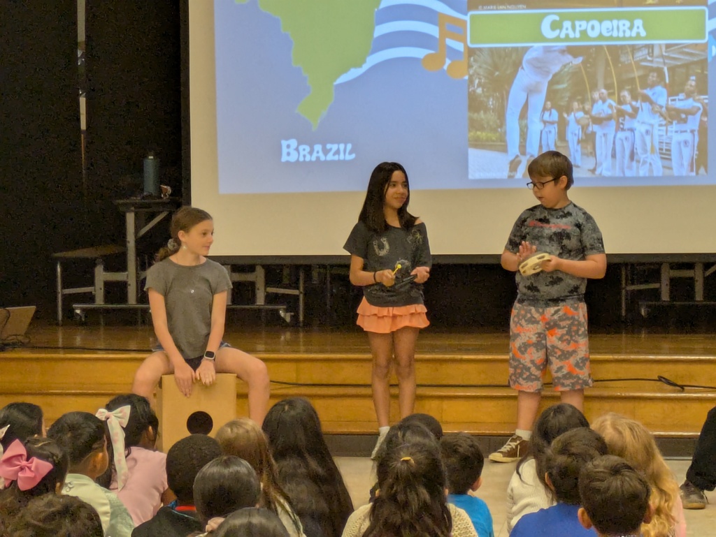 Three students play percussion instruments from Brazil.