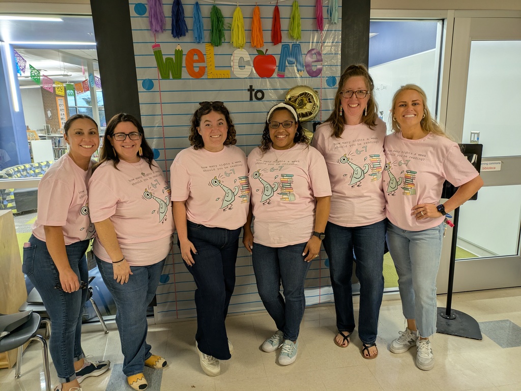 Teachers pose in matching 6-7 t-shirts