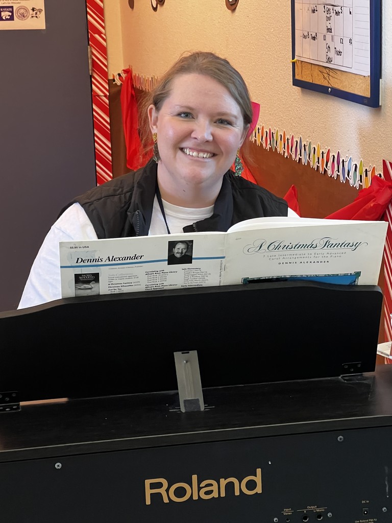 SLES teacher plays holiday carols for students as they arrive.
