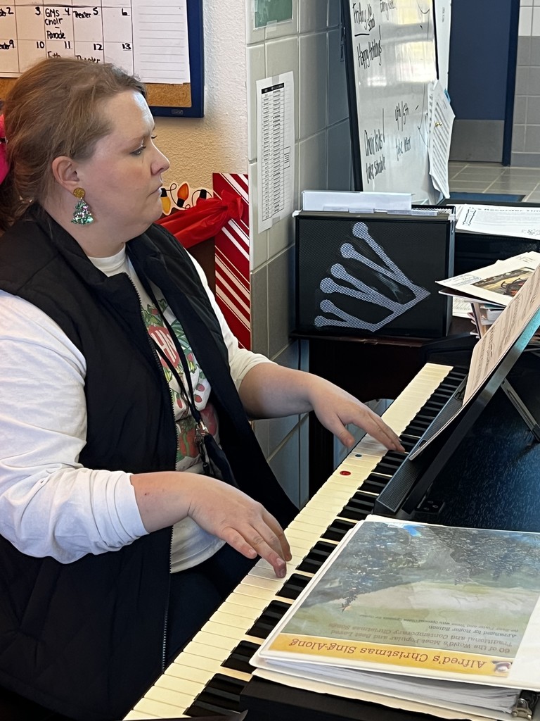 SLES teacher plays holiday carols for students as they arrive.