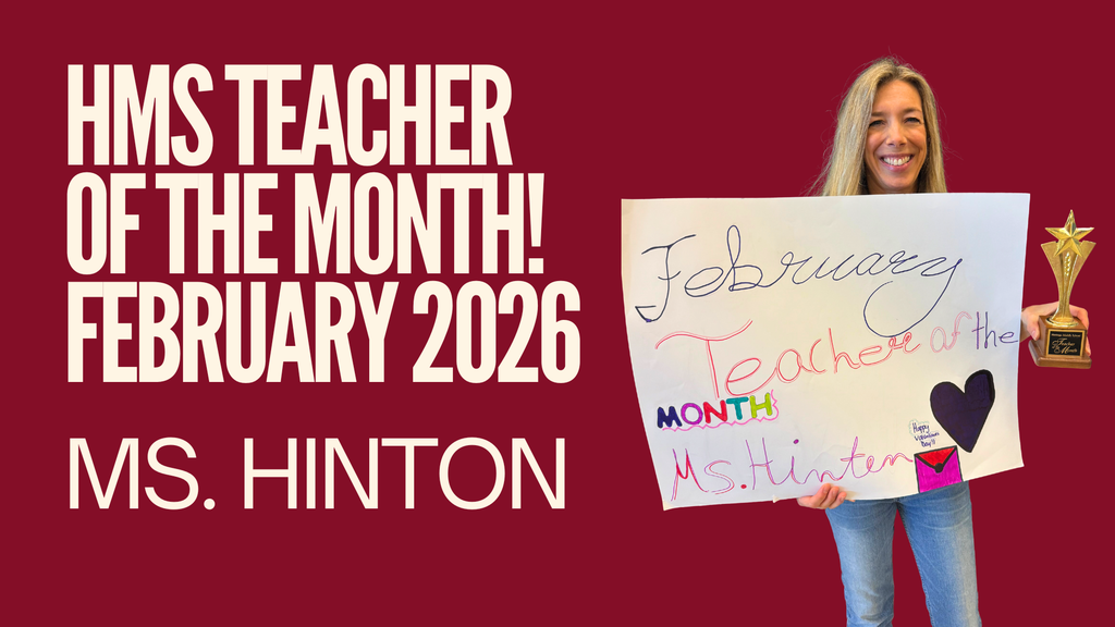 Ms. Hinton holding a Teacher of the Month poster