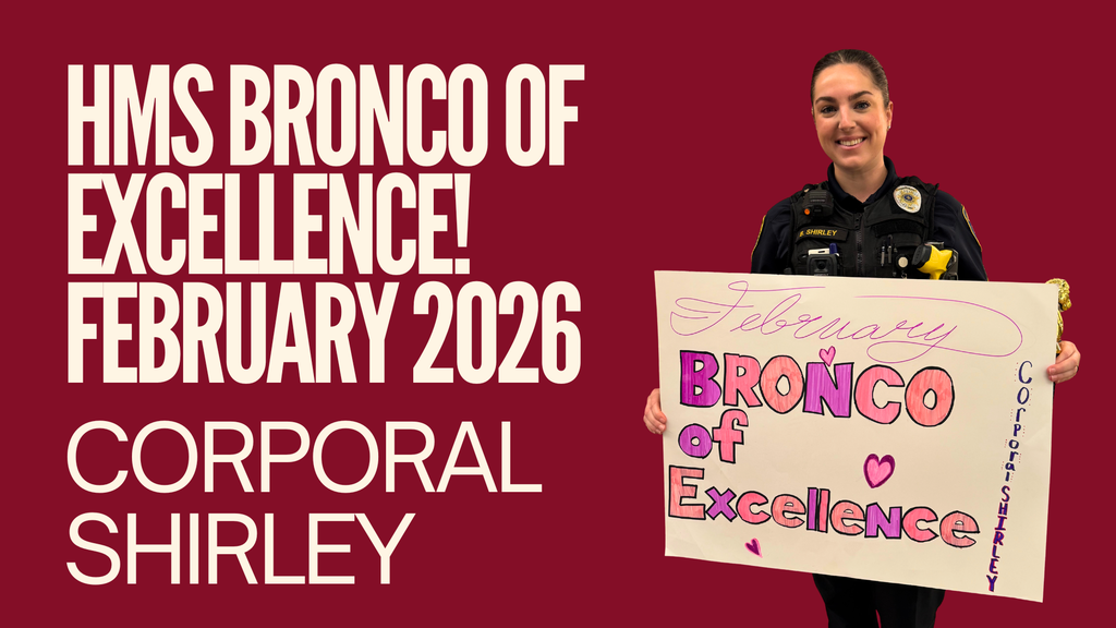 Corporal Shirley holding a Bronco of Excellence poster