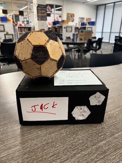 soccer ball made out of cork sitting on a black box