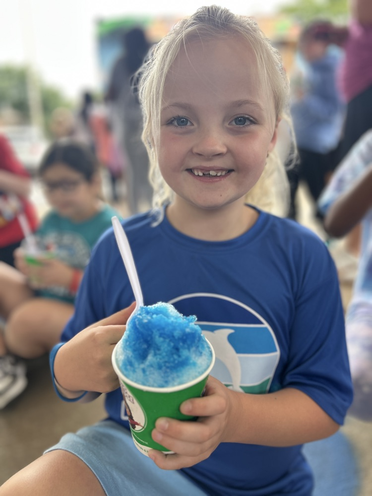 female child smiling with snowcone