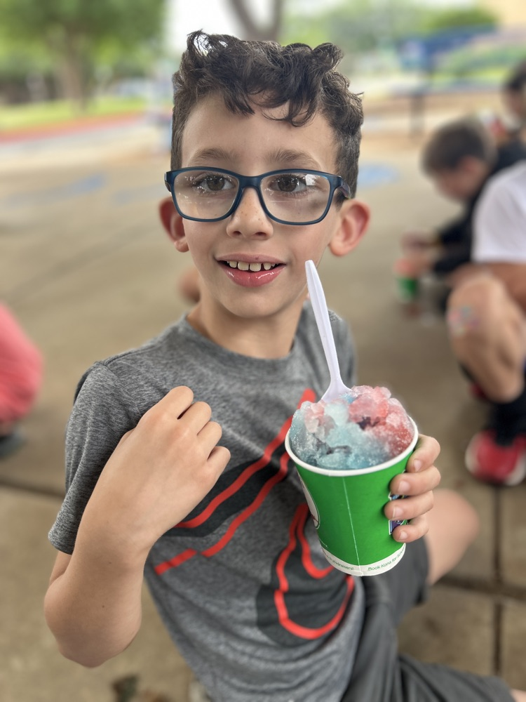 male child smiling with snow cone
