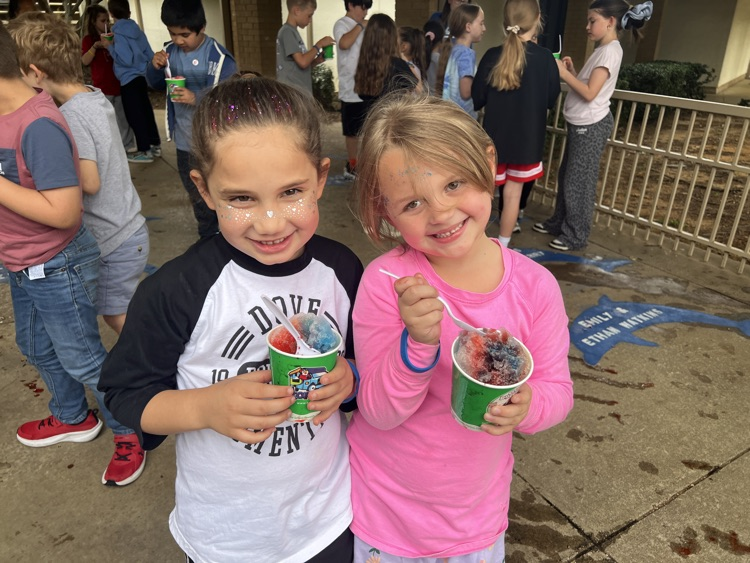 two female children smiling with snowcones