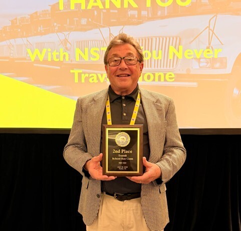  Bus driver holding plaque