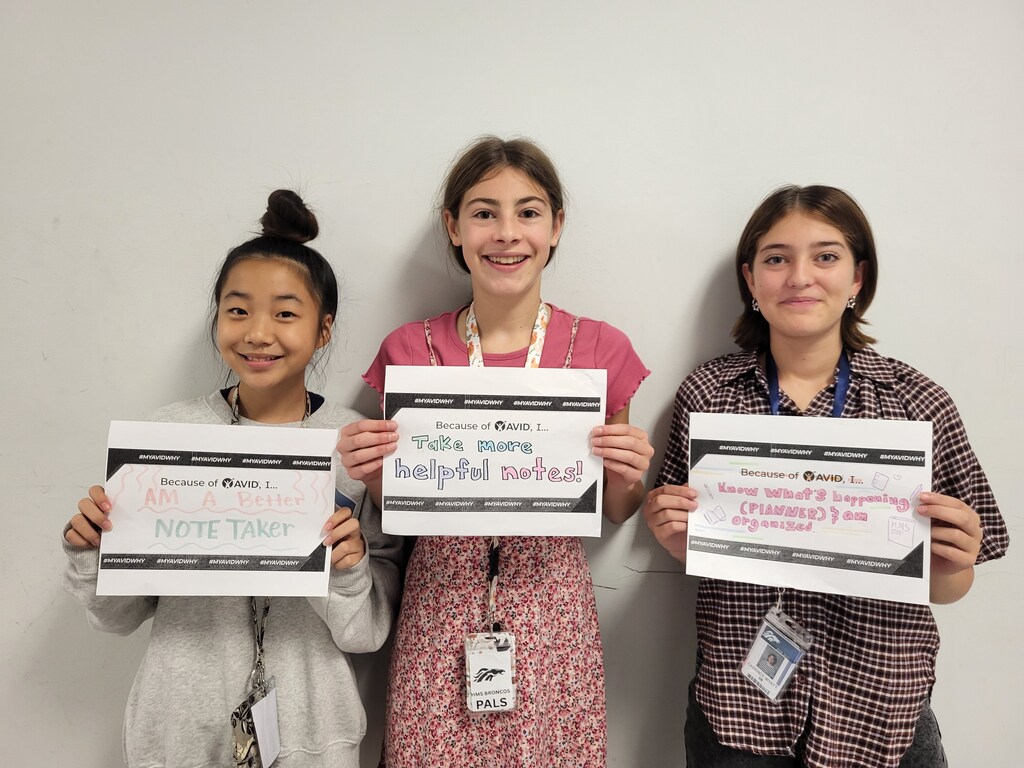 Students show their answers to the question "Because of AVID I..."