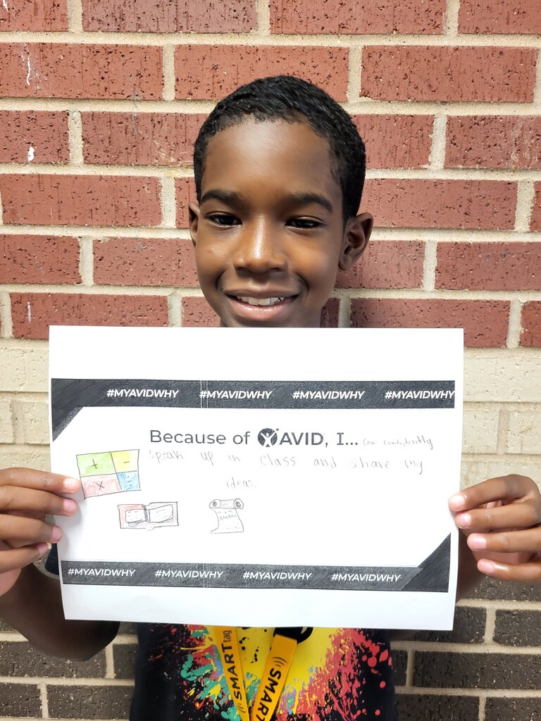 Students show their answers to the question "Because of AVID I..."