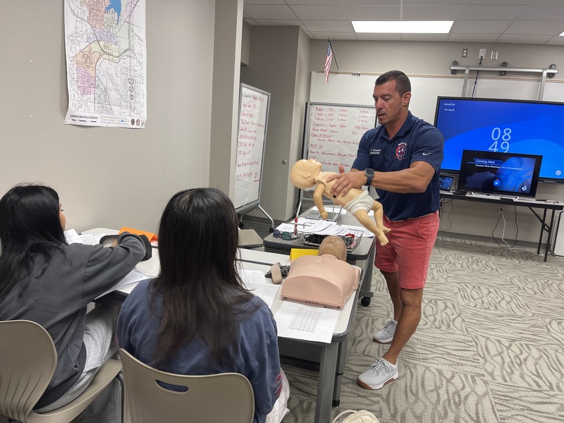 Firefighter instructor demonstrates CPR