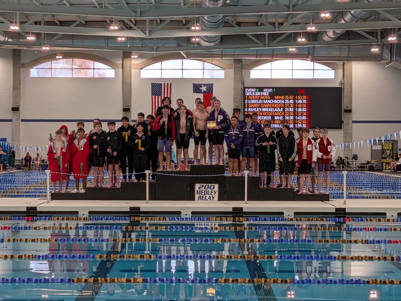 Boys Swim Teams Posing On Medal Podiums