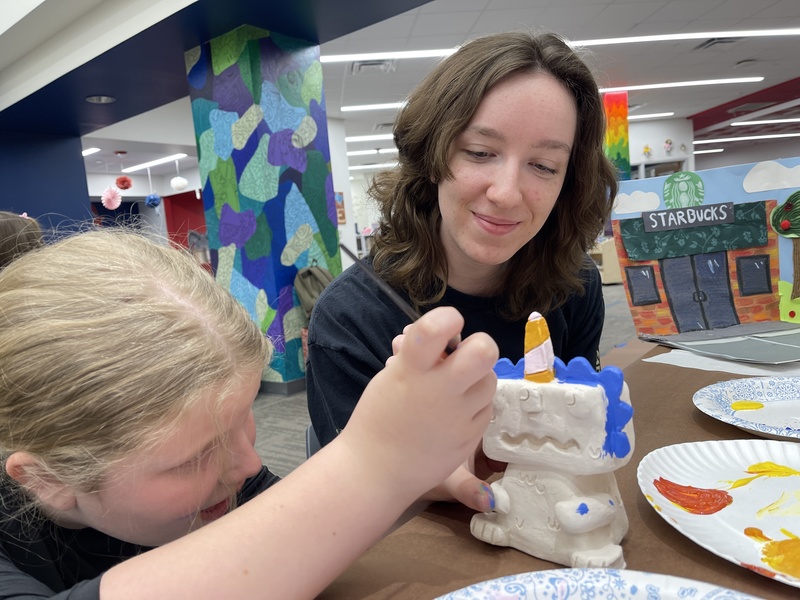 Student watching student paint