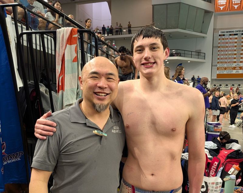 Aiden Tokarski posing with Head Swim Coach Daniel Jau at State Championship meet