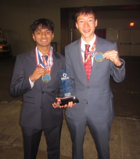 students holding medals