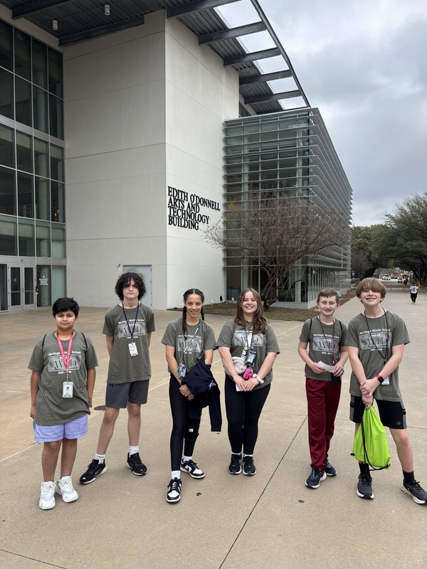 7th grade group at UTD standing in front of a building
