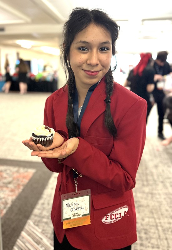 Olivia holding her cupcake