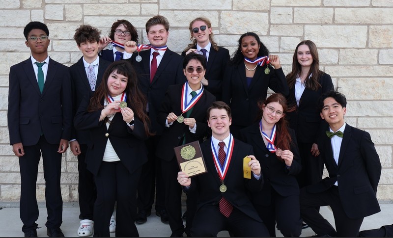 Group of students holding medals