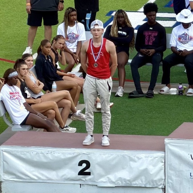 Grayson standing on the podium at regionals