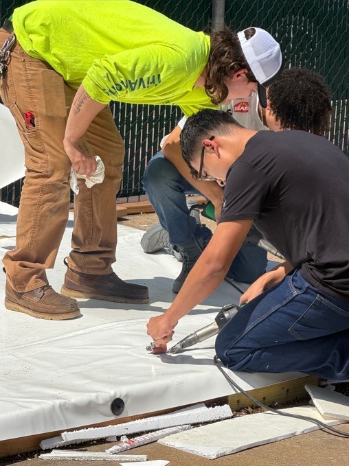 construction worker teaches student
