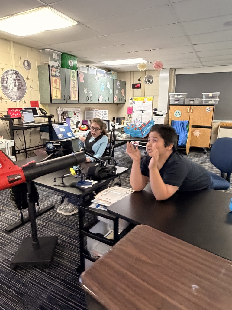 Students engaged in a classroom conversation about fall weather
