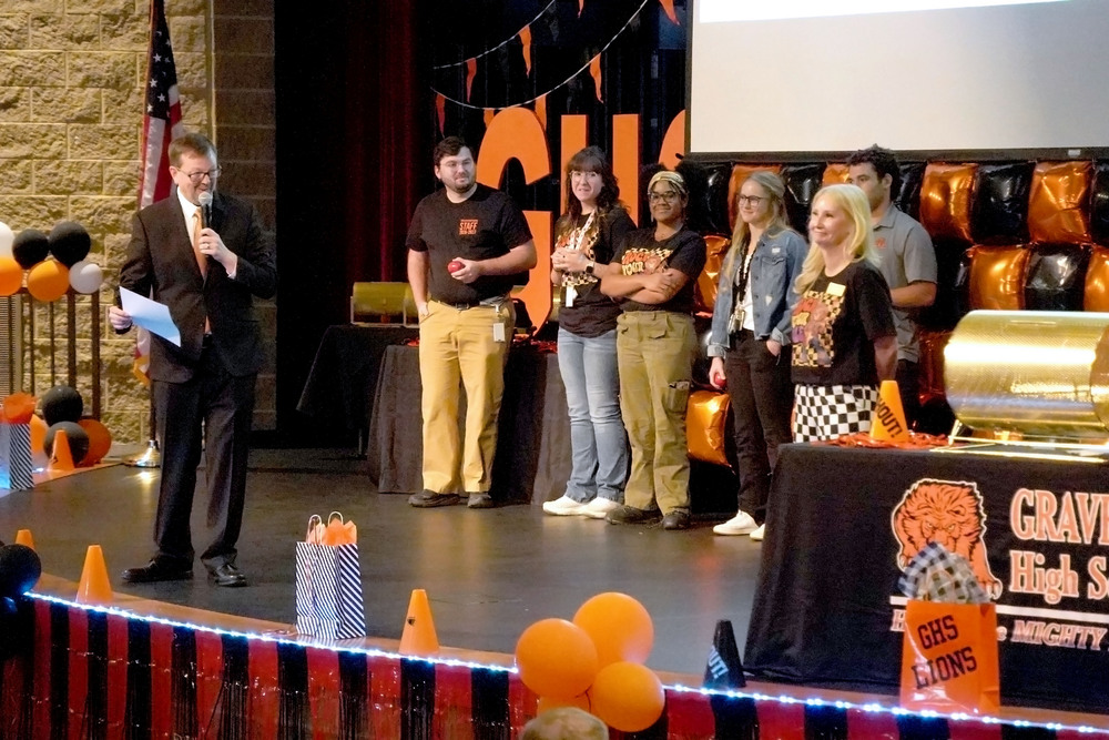 Superintendent Jeff Gravette and Glenn Duffy Elementary Principal Brandi Newsom lead new teachers in a spelling bee covering hard to spell district names