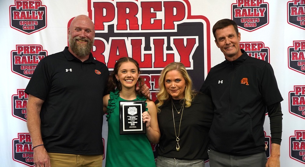 Parker Pittman with her coaches, two of whom are her parents at the Prep Rally Sports event in Springdale