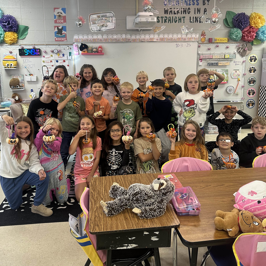 Students holding their decorated pumpkins with pride