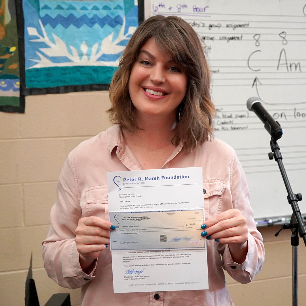 Mrs. Galloway holding a grant check