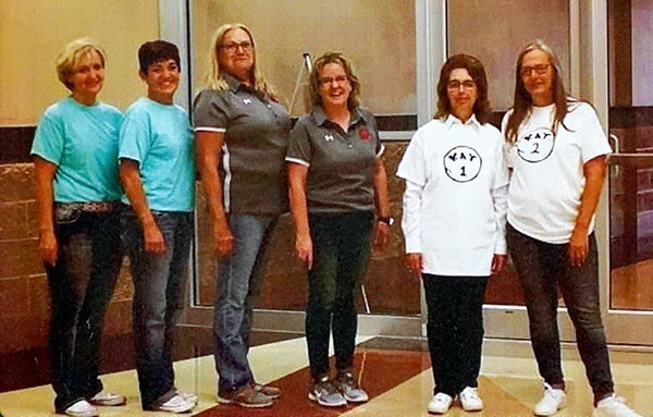 Kay Russow posing for a photo of a work twins dress-up day with another staff member named Kay.