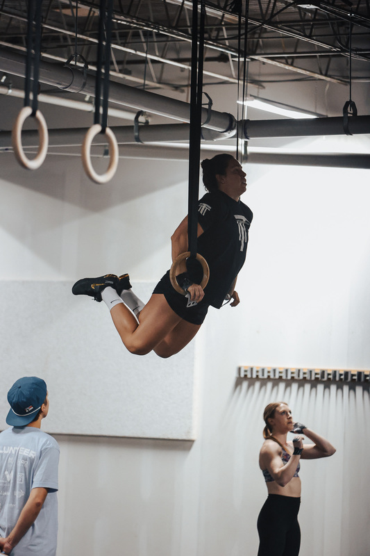 Madie Edwards doing gymnastics in a CrossFit Gym