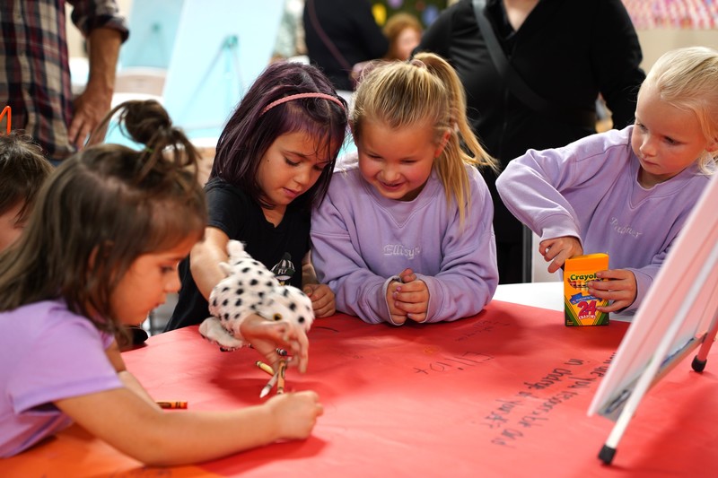 A group of young students work on their LIM pledge