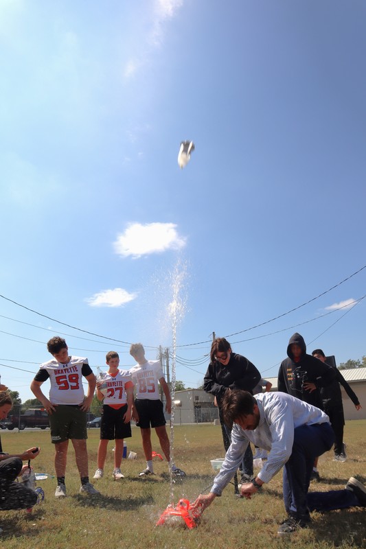 Mr. Leach leading in air-pressure-powered Water Bottle Rocket experiments