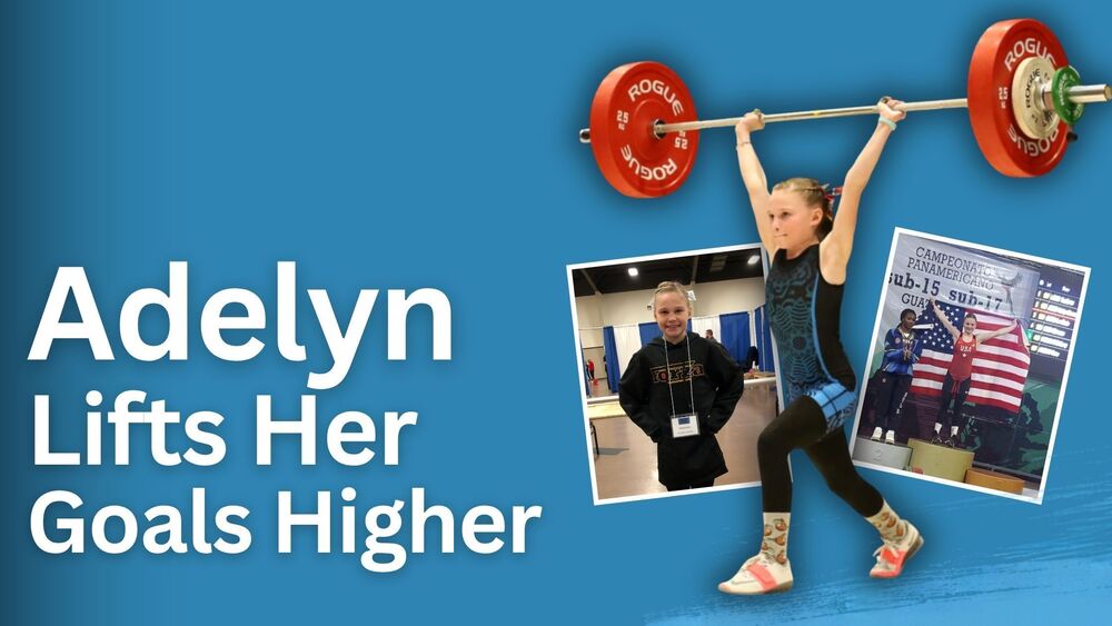 Adelyn with barbell over her head, and her winning awards behind american flag