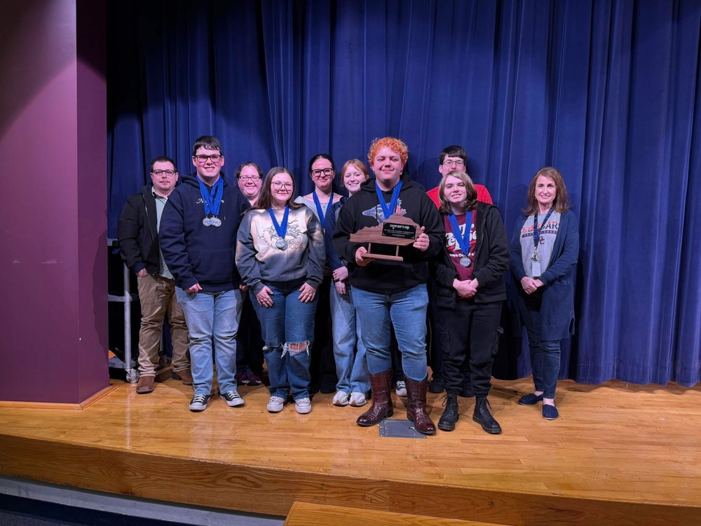 GCHS Academic Team on a stge holding District Championship award