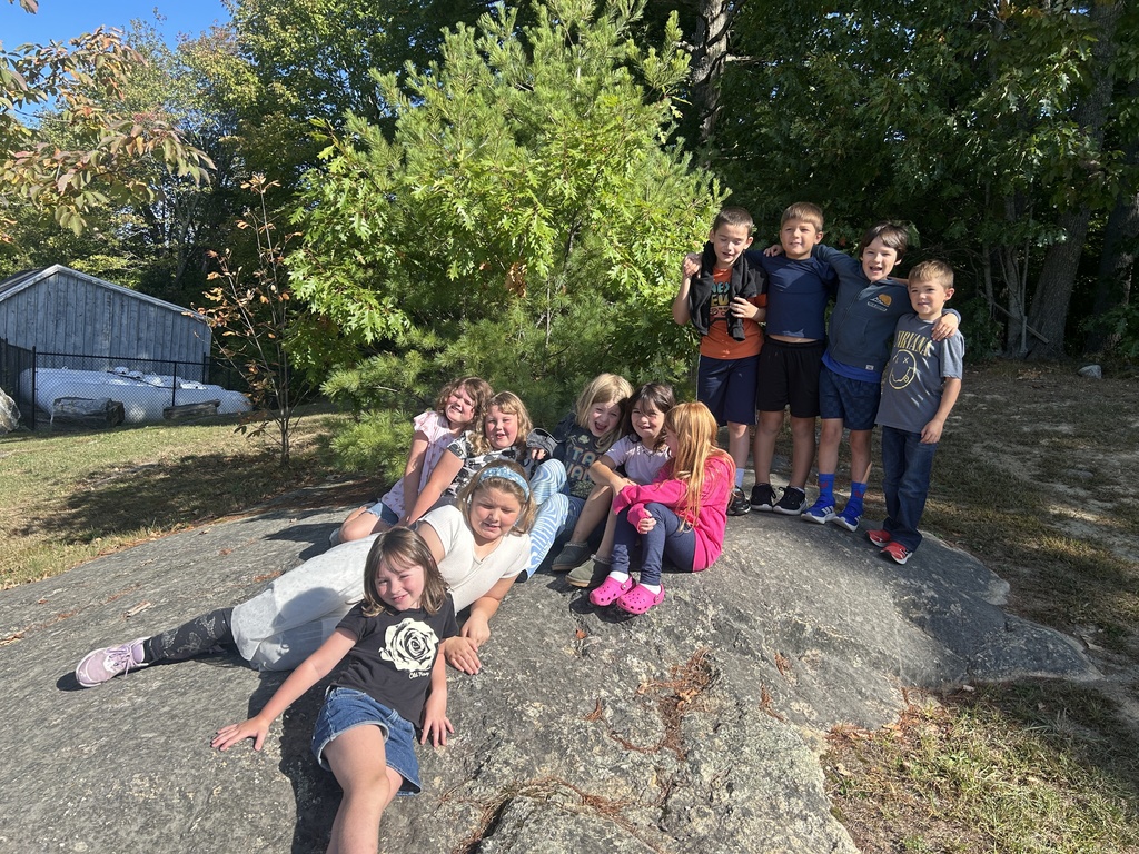 Mrs. Michaud's class taking a class photo before they walk up to play in the woods for a morning break. 