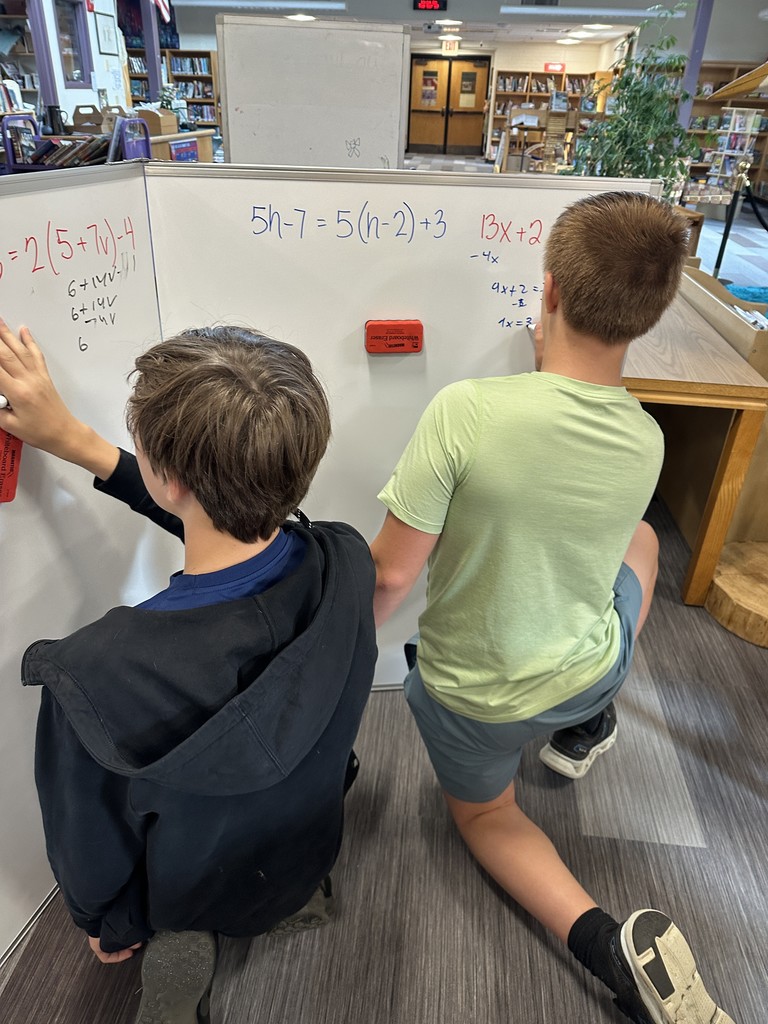 8th grade Algebra students use giant whiteboards to solve their equations! 