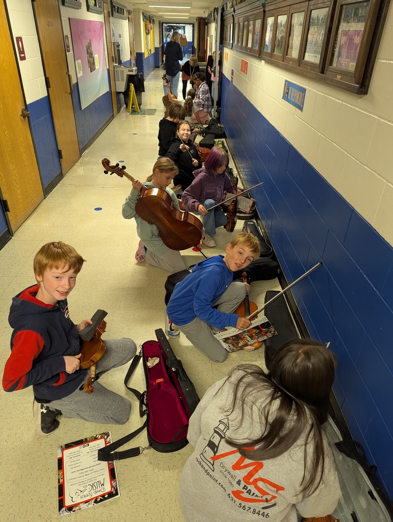 Students getting ready for orchestra practice with Kaity